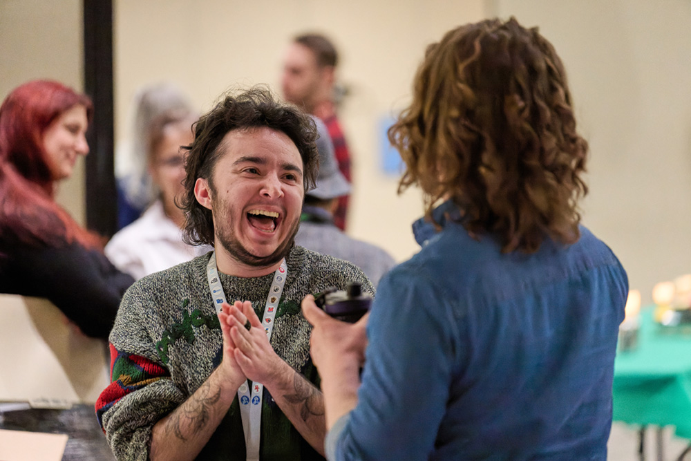 Two educators talk to each other at a conference.